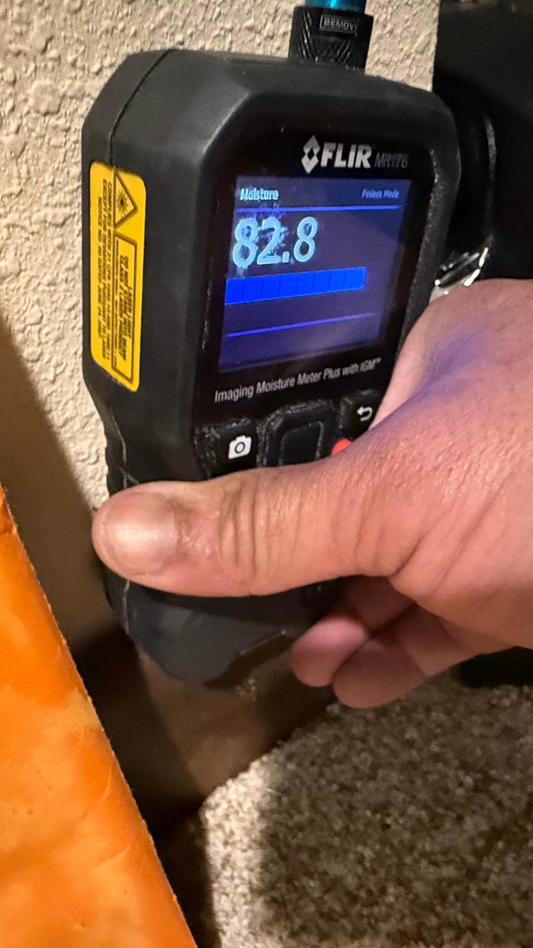 Moisture detection meter identifying elevated moisture levels during a professional water damage inspection by Power Restoration of Rockford.