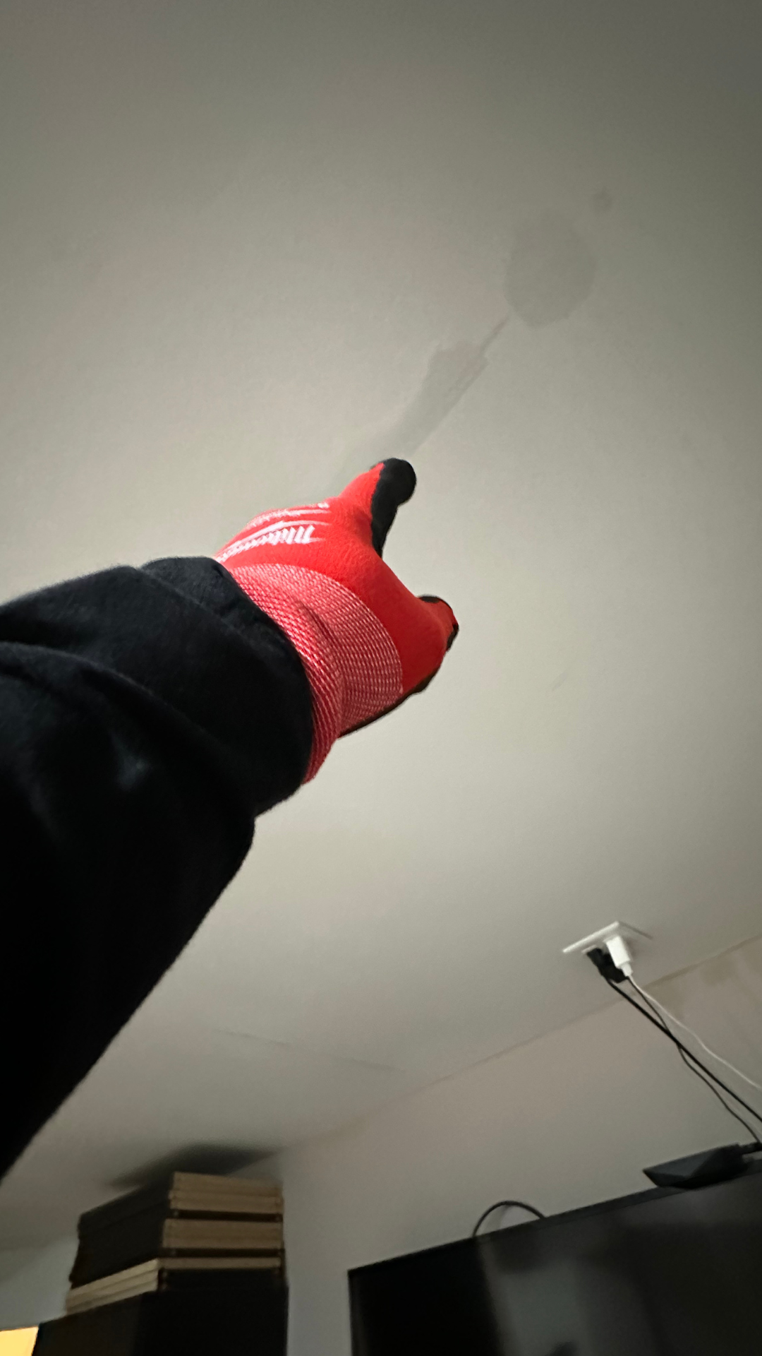 Homeowner pointing toward ceiling damage during a residential property inspection by Power Restoration of Rockford.